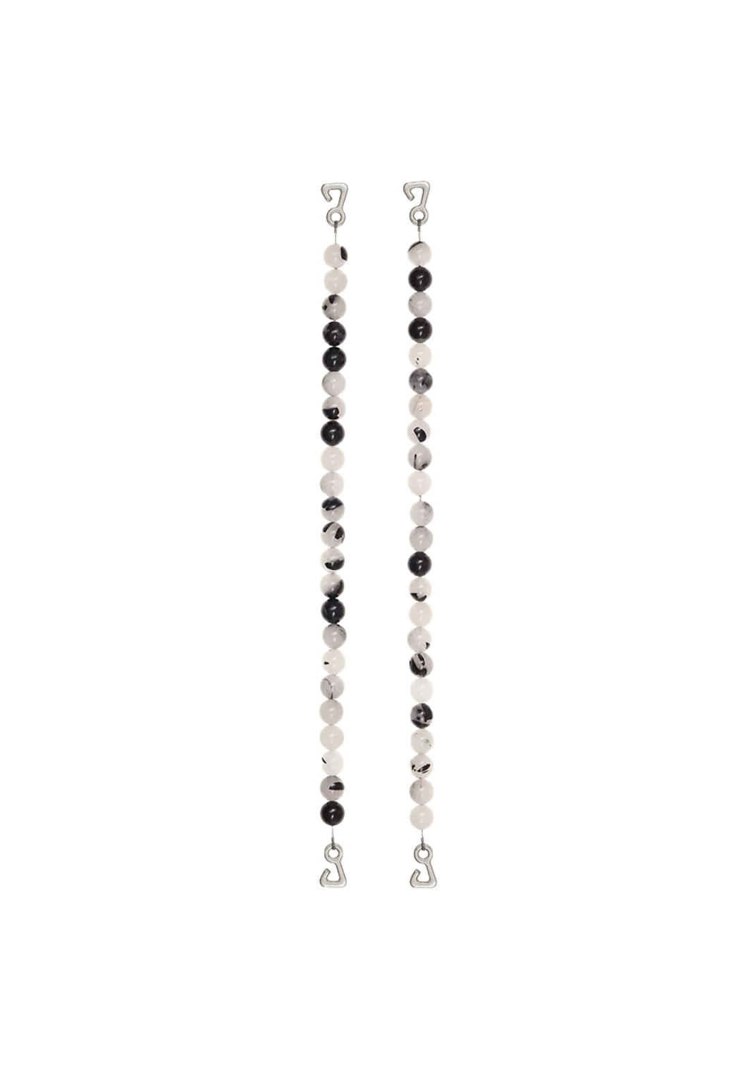 Swimwear straps featuring black tourmaline and quartz, symbolizing Casablanca's 'White House' nickname with bold black and white contrast.