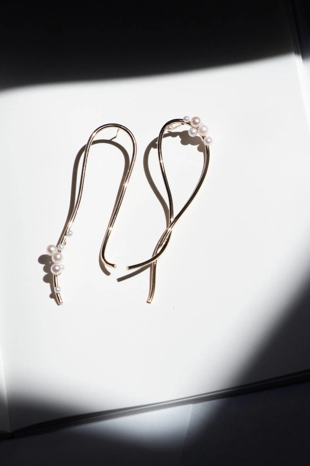 Completedworks expressive earrings with flowing freshwater pearls, designed for movement and elegance.