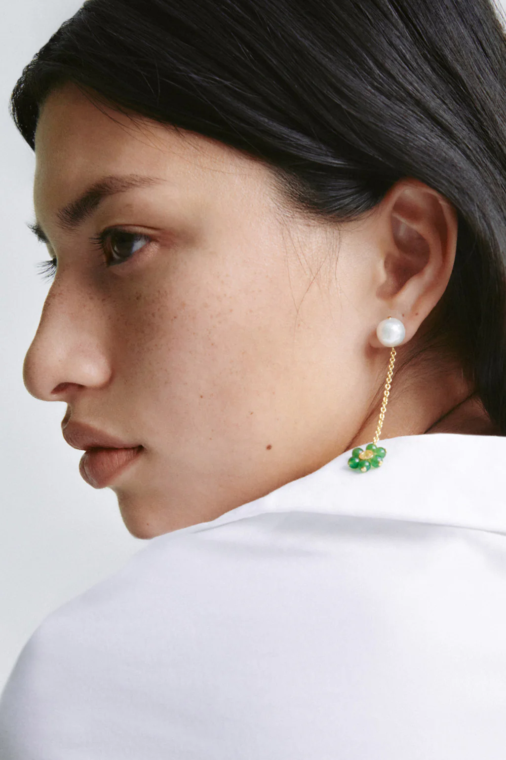 Completedworks earrings crafted from recycled gold, featuring pearl, zirconia, and jade bead details for a refined look.