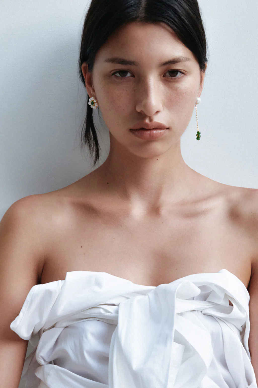 Elegant recycled gold earrings by Completedworks, adorned with pearls, zirconia, and jade beads for a timeless design.