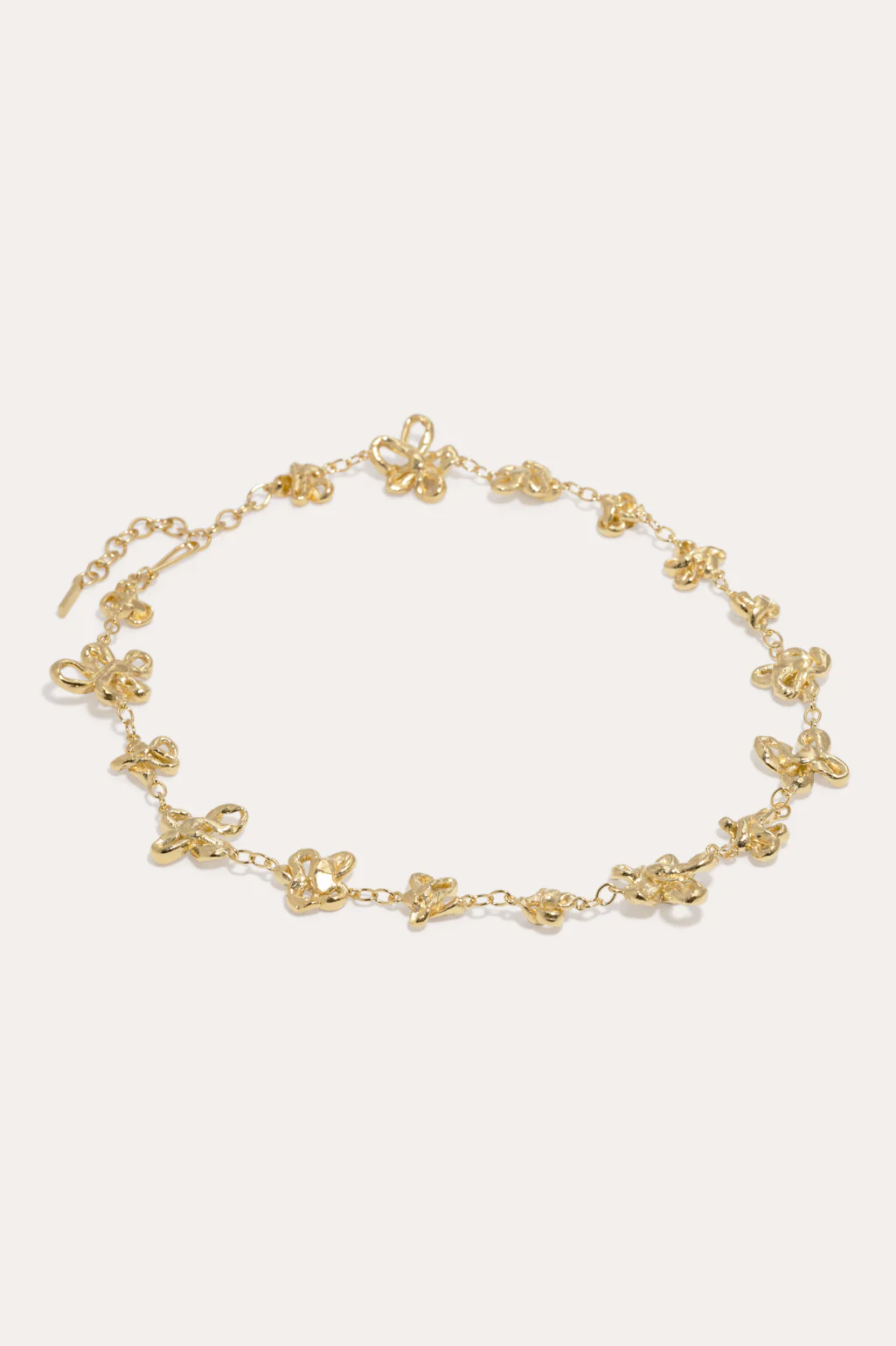 Elegant 18ct gold-plated flower chain necklace by Completedworks, designed to rest gracefully on the collarbone.
