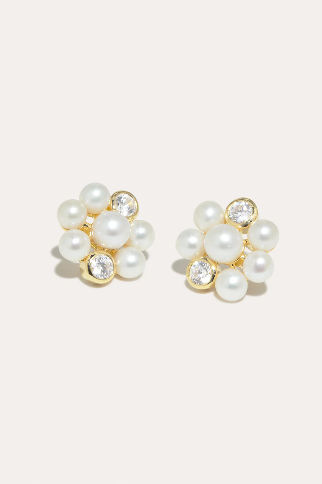 Completedworks gold vermeil earrings with luminous freshwater pearls and sparkling zirconia details.