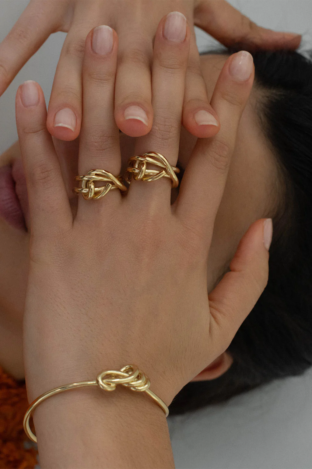 Elegant 18ct gold-plated bracelet with a refined knotted design, offering a sleek and timeless look.