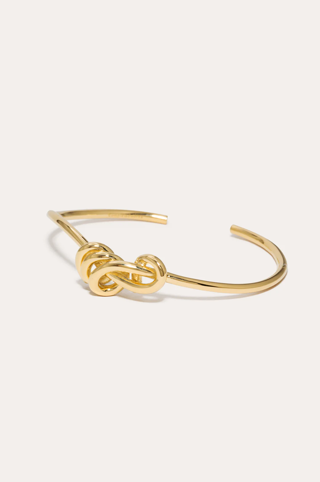 Sculptural knotted bracelet in 18ct yellow gold plating by Completed Works, designed for a smooth, elegant fit.