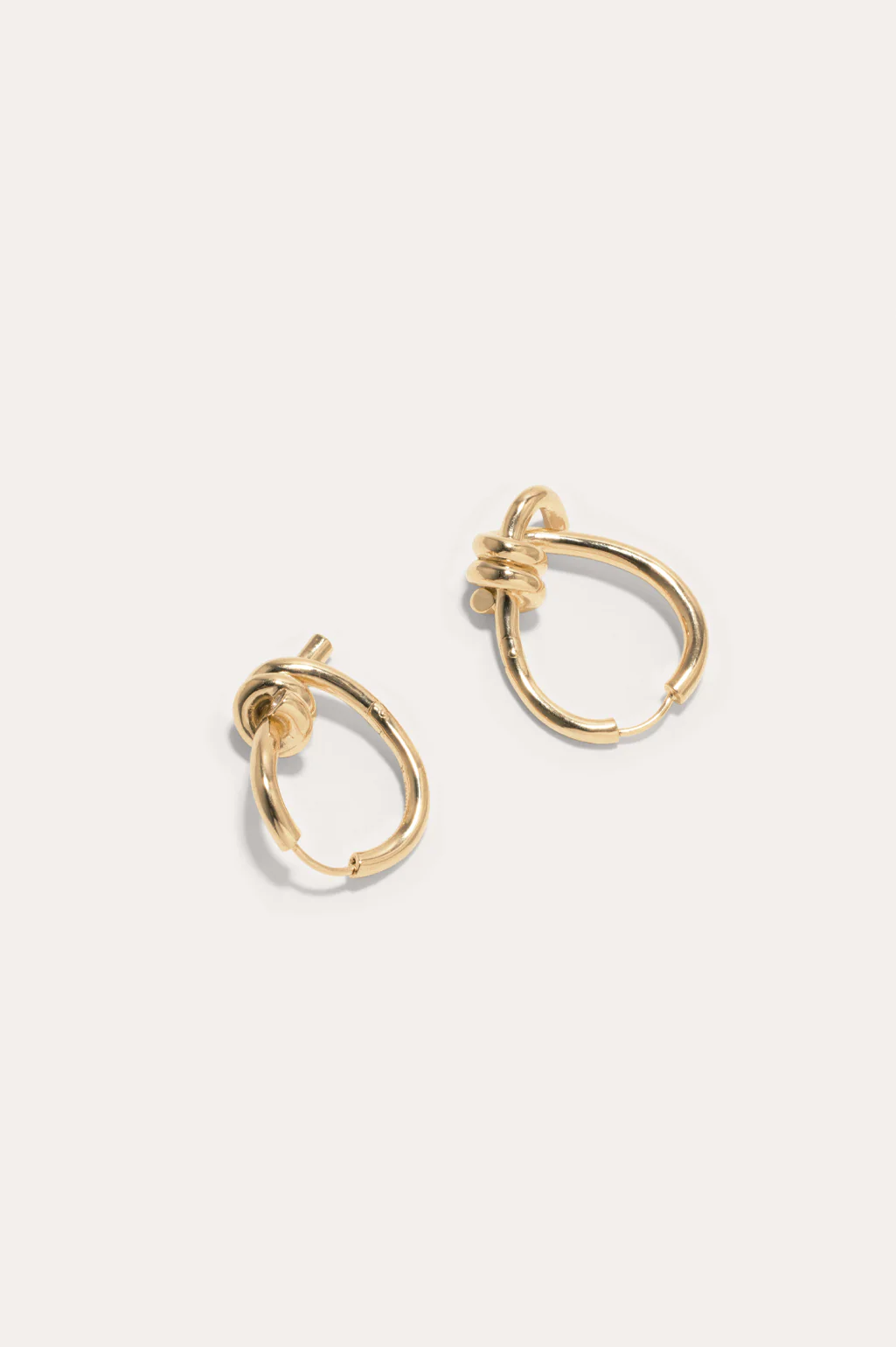 Completedworks sculptural gold vermeil hoop earrings with a unique twisted design, blending minimalism and sophistication.