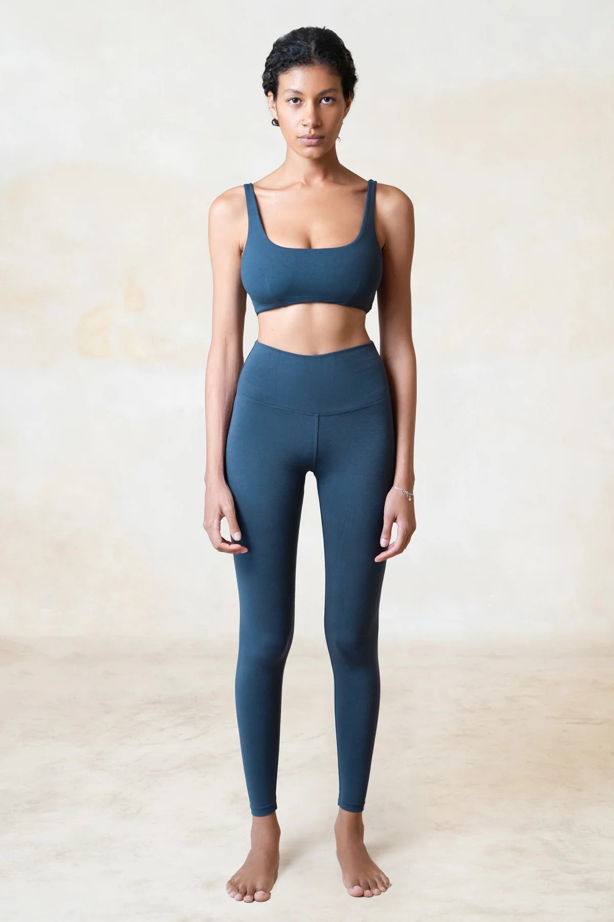 Woman wearing blue yoga leggings made from sustainable organic bamboo.