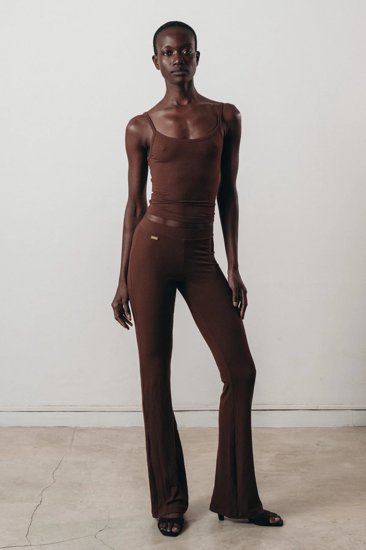 Eco-friendly brown ribbed flare pants crafted from soft Ecovero™ viscose.