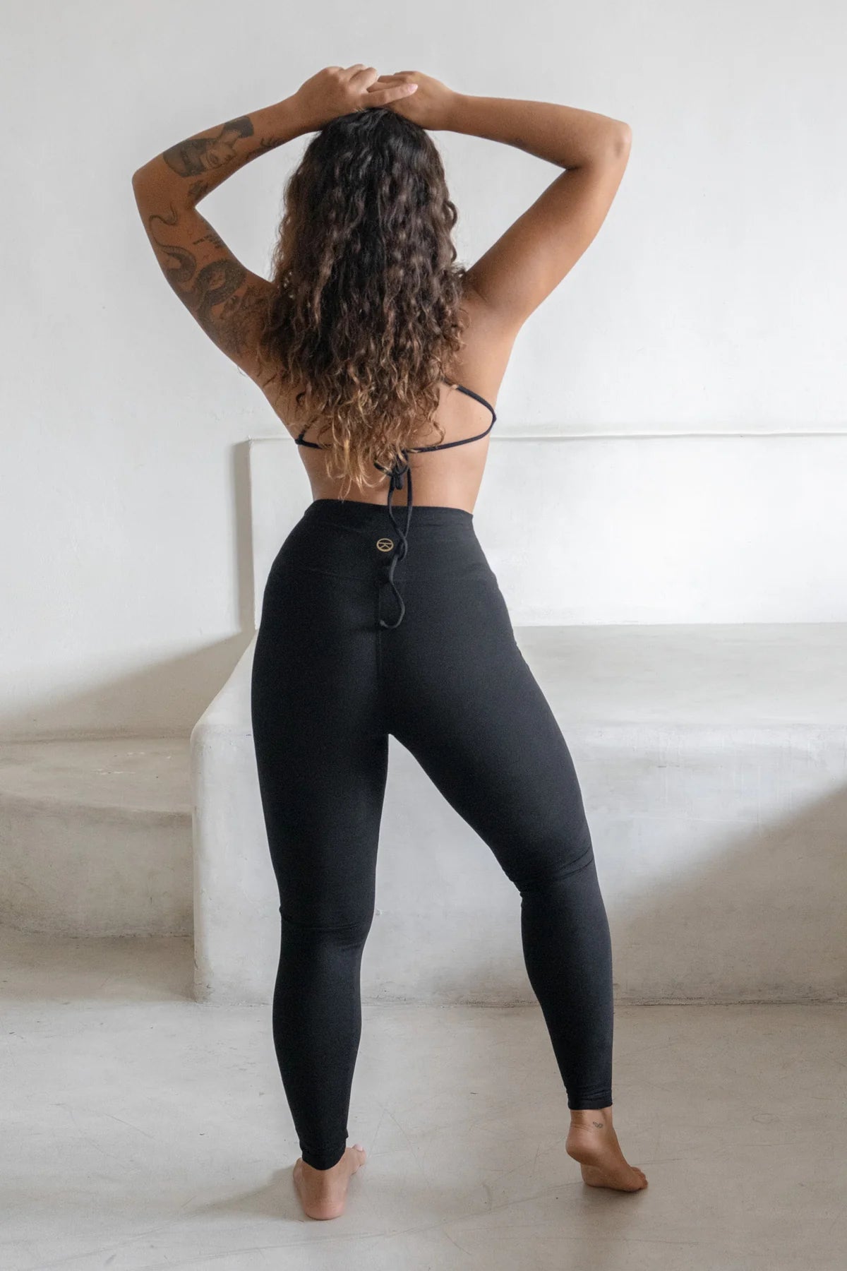 Minimal black bamboo yoga leggings offering comfort, stretch, and breathability.