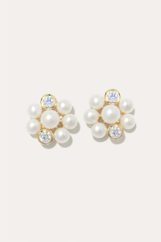 Delicate gold vermeil earrings featuring freshwater pearls and zirconia accents by Completedworks.