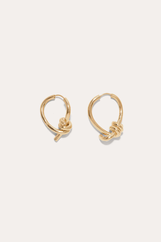 Sleek and contemporary twisting hoop earrings in gold-plated silver by Completedworks, perfect for everyday elegance